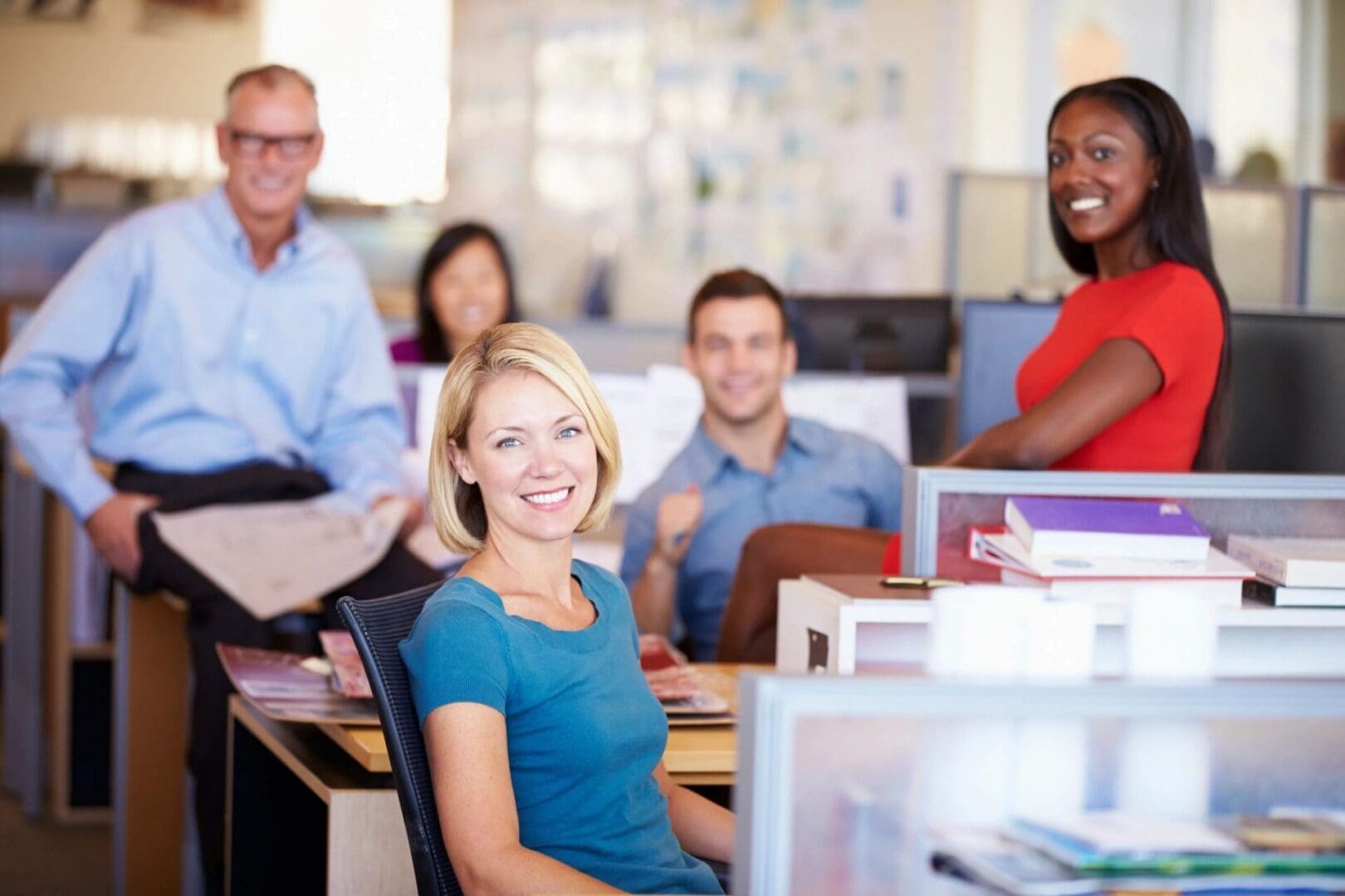 Smiling woman sitting at desk in office.