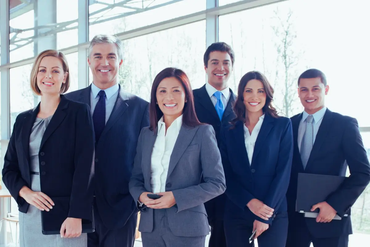 Smiling business team in suits.