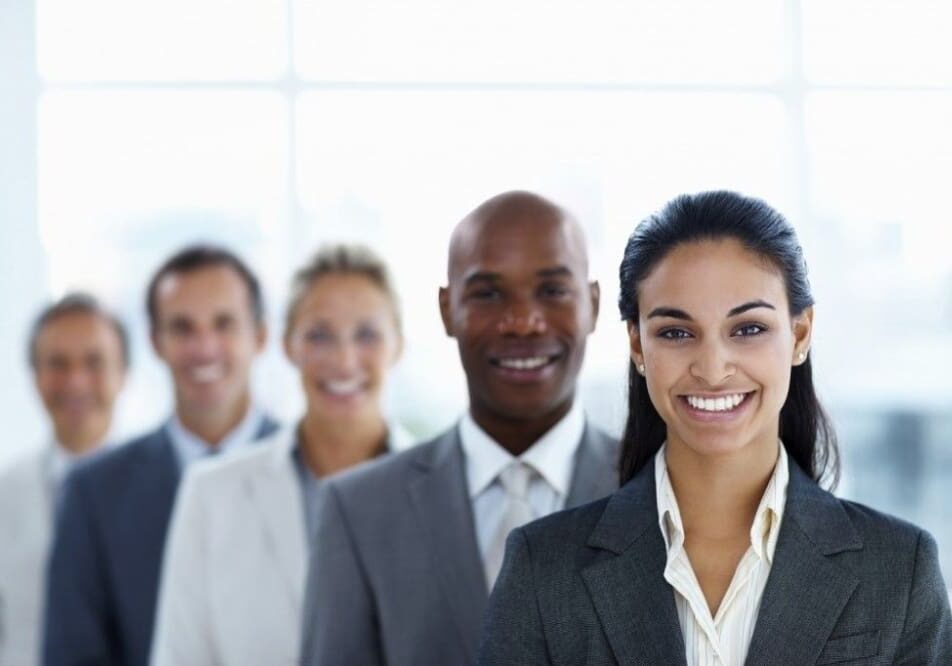 Smiling diverse business team in suits.